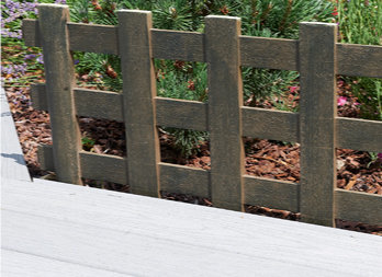 Plastic border with a round wood slat look, installed in the soil